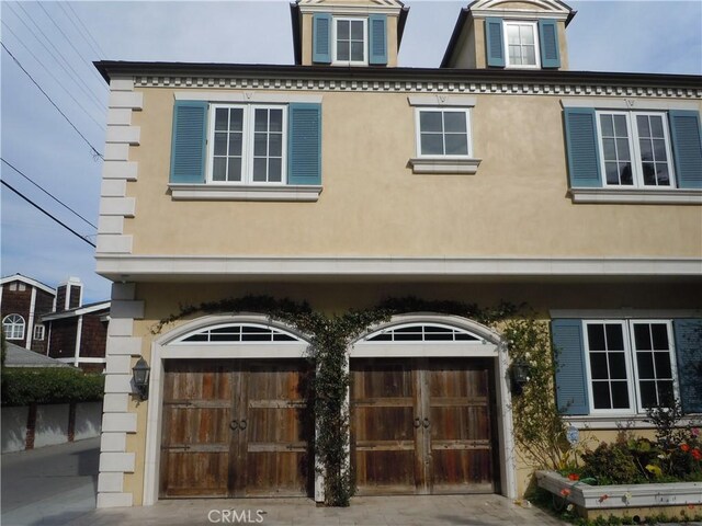 59 Rivo Alto Canal, Long Beach, CA 90803 - view of front of home with an attached garage and stucco siding