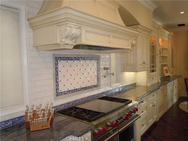 59 Rivo Alto Canal, Long Beach, CA 90803 - kitchen featuring double oven range, cream cabinetry, tasteful backsplash, ornamental molding, and glass insert cabinets