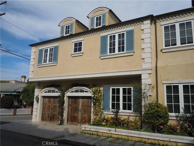 59 Rivo Alto Canal, Long Beach, CA 90803 - view of front facade featuring a garage, concrete driveway, and stucco siding
