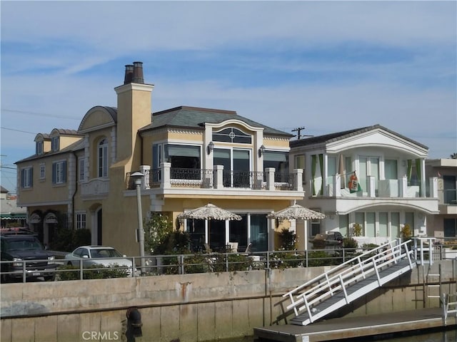 59 Rivo Alto Canal, Long Beach, CA 90803 - rear view of house with a balcony, a chimney, and stucco siding