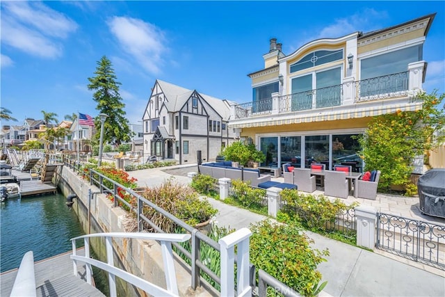 59 Rivo Alto Canal, Long Beach, CA 90803 - rear view of property featuring an outdoor living space, a balcony, a water view, a patio area, and a chimney