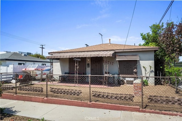 20717 Raymond Ave, Torrance, CA 90502 - view of front of property featuring a shingled roof, a fenced front yard, and stucco siding