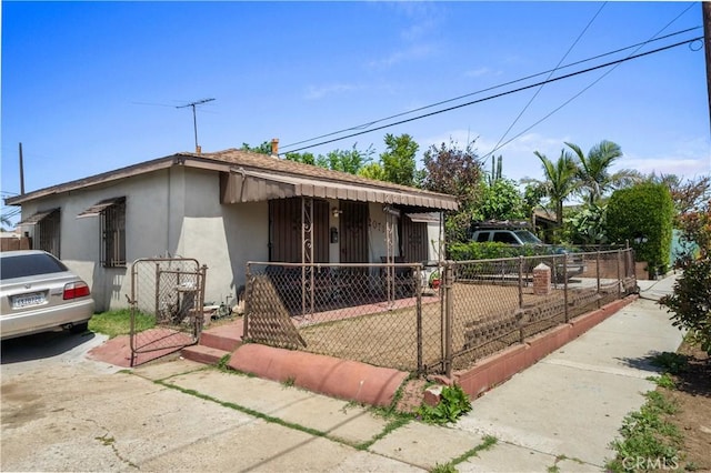 20717 Raymond Ave, Torrance, CA 90502 - view of front of home featuring a fenced front yard, a gate, and stucco siding