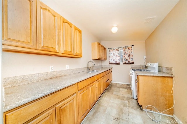 17941 E Payson St, Azusa, CA 91702 - kitchen featuring white gas stove, a sink, light countertops, and baseboards