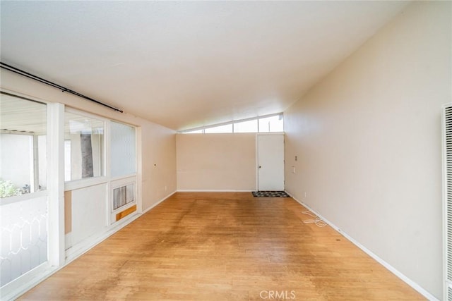 17941 E Payson St, Azusa, CA 91702 - spare room featuring light wood finished floors, lofted ceiling, a heating unit, and baseboards