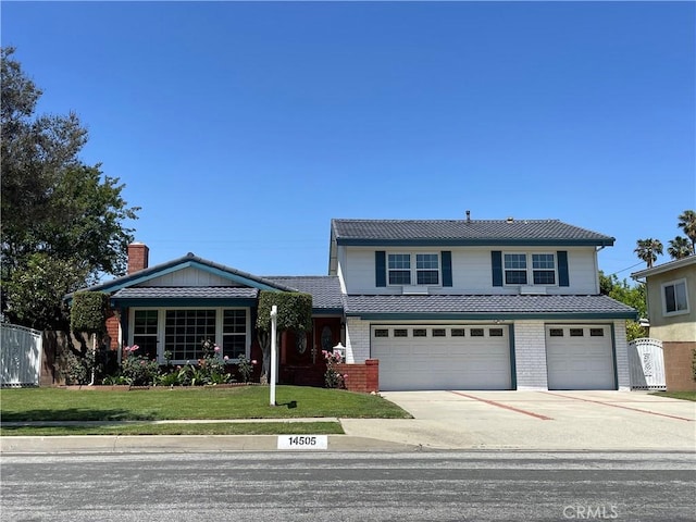 14505 Palm Ave, Hacienda Heights, CA 91745 - traditional home featuring driveway, a garage, and brick siding