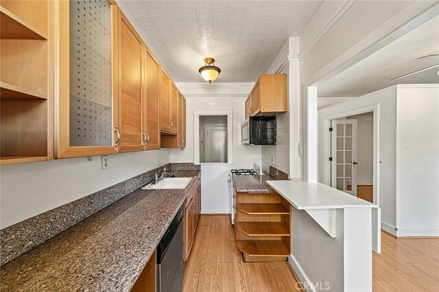 315 W 3rd St Unit 203, Long Beach, CA 90802 - kitchen featuring open shelves, a sink, light wood-style flooring, dishwasher, and brown cabinetry