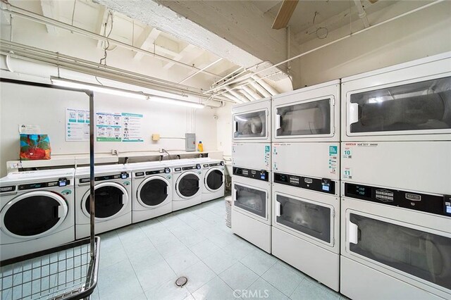315 W 3rd St Unit 203, Long Beach, CA 90802 - shared laundry room featuring stacked washer / dryer, washer and dryer, light tile patterned floors, and electric panel