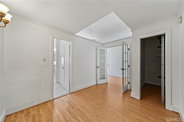 315 W 3rd St Unit 203, Long Beach, CA 90802 - empty room featuring ornamental molding, light wood-type flooring, french doors, baseboards, and a chandelier