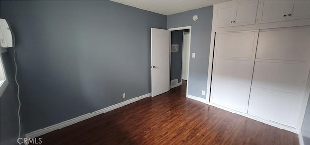 7107 Coldwater Canyon Ave, North Hollywood, CA 91605 - unfurnished bedroom with dark wood-type flooring, baseboards, a closet, and a textured ceiling