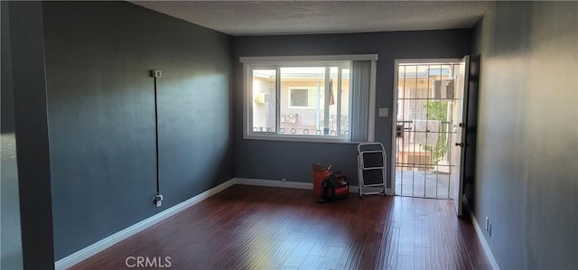 7107 Coldwater Canyon Ave, North Hollywood, CA 91605 - foyer featuring dark wood finished floors, baseboards, and a textured ceiling