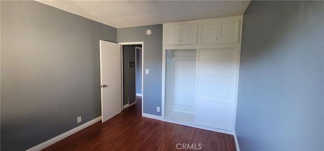7107 Coldwater Canyon Ave, North Hollywood, CA 91605 - unfurnished bedroom featuring dark wood-style floors, a textured ceiling, baseboards, and a closet