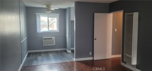 7107 Coldwater Canyon Ave, North Hollywood, CA 91605 - empty room featuring a heating unit, wood finished floors, a ceiling fan, an AC wall unit, and baseboards