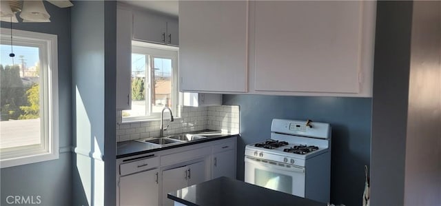 7107 Coldwater Canyon Ave, North Hollywood, CA 91605 - kitchen featuring white gas range oven, a sink, dark countertops, and backsplash