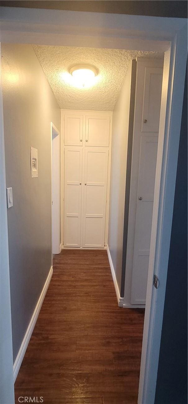 7107 Coldwater Canyon Ave, North Hollywood, CA 91605 - hall with dark wood-style floors, baseboards, and a textured ceiling