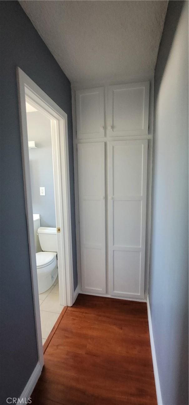 7107 Coldwater Canyon Ave, North Hollywood, CA 91605 - corridor with wood finished floors, baseboards, and a textured ceiling