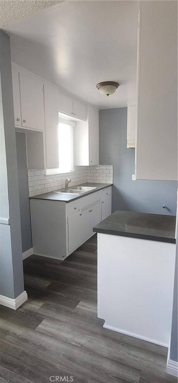 7107 Coldwater Canyon Ave, North Hollywood, CA 91605 - kitchen featuring white cabinets, decorative backsplash, a sink, and dark wood finished floors