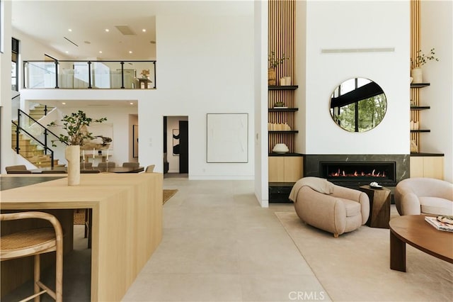 2321 Mesa Dr, Newport Beach, CA 92660 - living room featuring a high ceiling, stairway, a fireplace, recessed lighting, and plenty of natural light