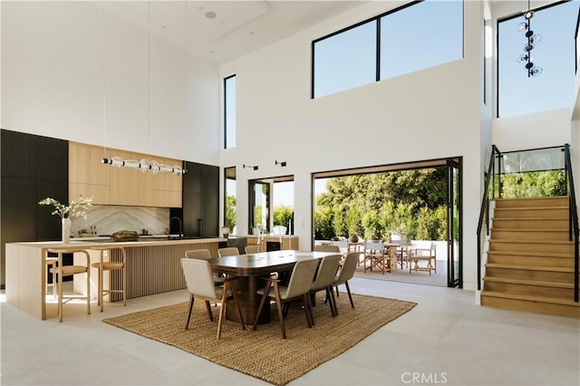 2321 Mesa Dr, Newport Beach, CA 92660 - dining room with a towering ceiling, stairway, and light tile patterned floors