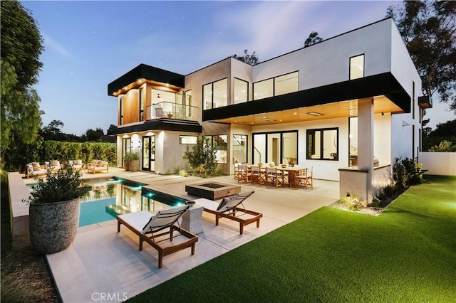 2321 Mesa Dr, Newport Beach, CA 92660 - rear view of property featuring a balcony, an outdoor living space, an outdoor pool, a patio area, and a lawn