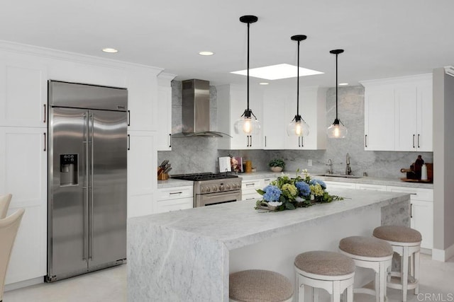 5918 Germaine Ln, La Jolla, CA 92037 - kitchen with high quality appliances, wall chimney range hood, a sink, a center island, and backsplash