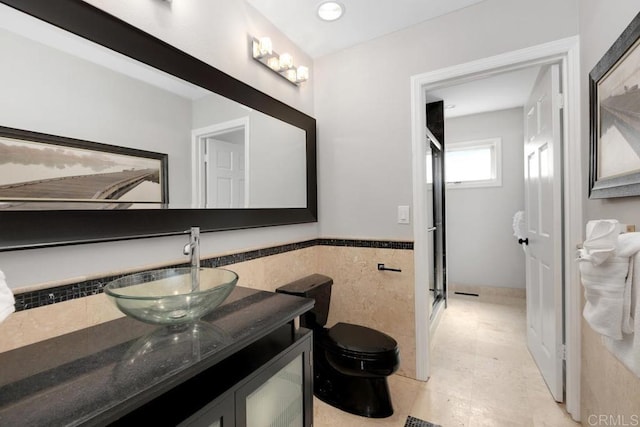 5918 Germaine Ln, La Jolla, CA 92037 - bathroom featuring tile walls, vanity, a stall shower, toilet, and a wainscoted wall