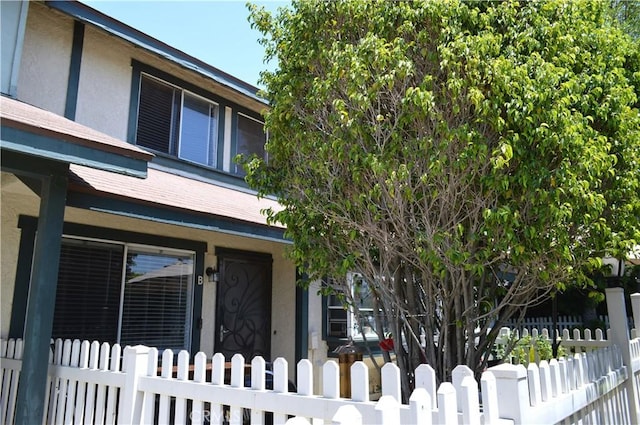 13321 Meyer Rd Unit B, Whittier, CA 90605 - view of home's exterior with stucco siding, a fenced front yard, and covered porch