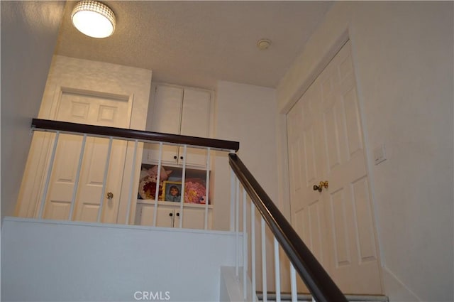 13321 Meyer Rd Unit B, Whittier, CA 90605 - stairway featuring a textured ceiling
