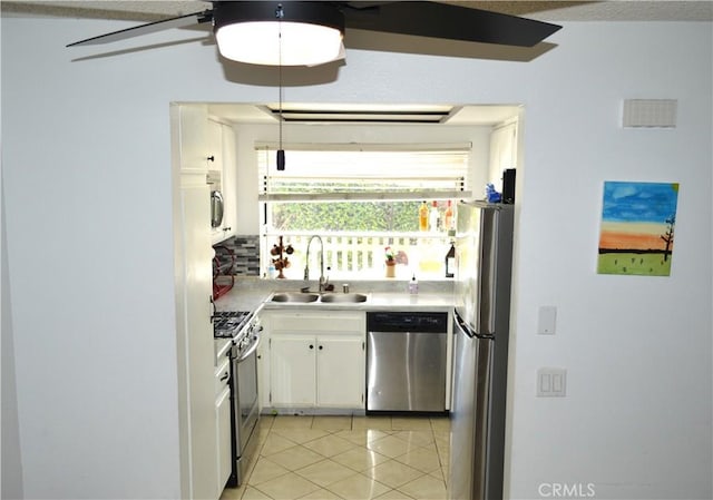 13321 Meyer Rd Unit B, Whittier, CA 90605 - kitchen featuring appliances with stainless steel finishes, a sink, light tile patterned floors, white cabinetry, and light countertops