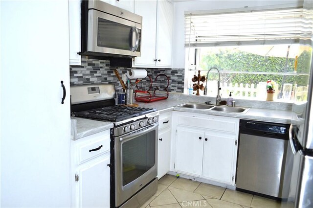 13321 Meyer Rd Unit B, Whittier, CA 90605 - kitchen with stainless steel appliances, a sink, light countertops, and white cabinets
