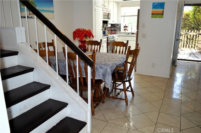 13321 Meyer Rd Unit B, Whittier, CA 90605 - dining space featuring stairway, light tile patterned floors, and baseboards