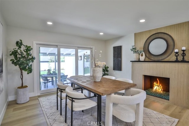 13181 Olympia Way N, Tustin, CA 92705 - dining area with light wood-style floors, recessed lighting, baseboards, and a lit fireplace