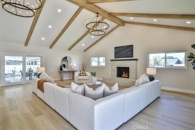 13181 Olympia Way N, Tustin, CA 92705 - living area featuring a chandelier, a fireplace, baseboards, light wood-style floors, and beam ceiling