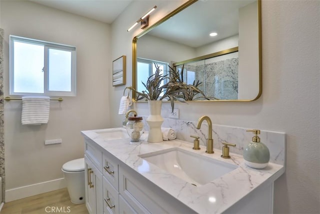 13181 Olympia Way N, Tustin, CA 92705 - full bathroom with double vanity, a shower with door, toilet, wood finished floors, and baseboards