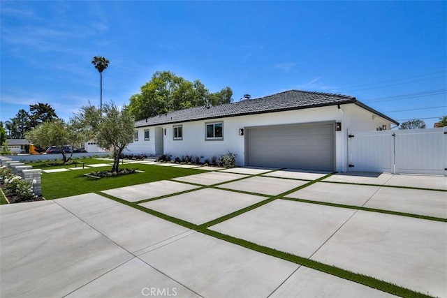 13181 Olympia Way N, Tustin, CA 92705 - single story home featuring a gate, a garage, driveway, and stucco siding