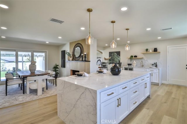 13181 Olympia Way N, Tustin, CA 92705 - kitchen featuring light wood-style floors, white cabinetry, recessed lighting, a sink, and open shelves