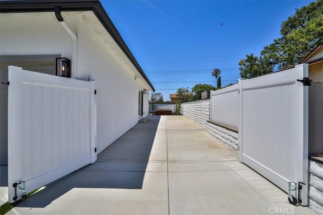 13181 Olympia Way N, Tustin, CA 92705 - view of side of home featuring a patio area and a gate