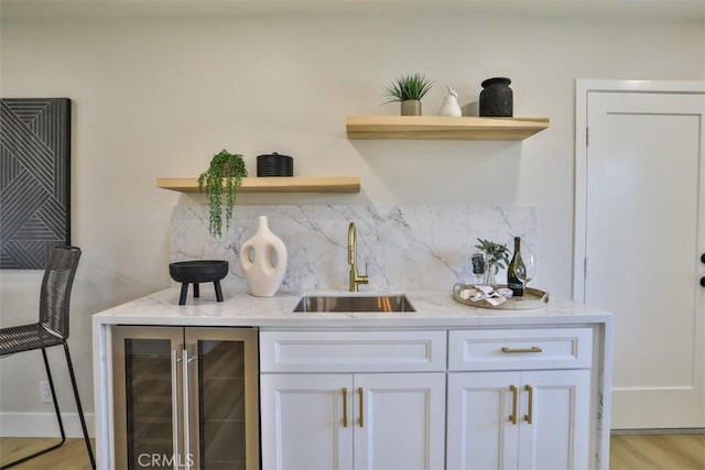 13181 Olympia Way N, Tustin, CA 92705 - indoor wet bar featuring beverage cooler, tasteful backsplash, and light wood-style floors