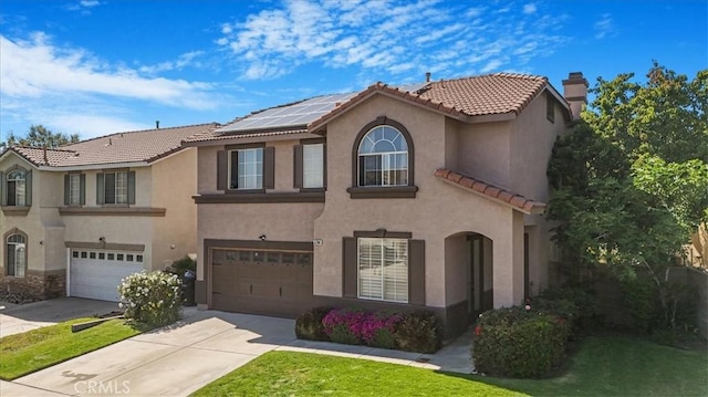 5794 Bay Hill Ln, Fontana, CA 92336 - mediterranean / spanish-style home featuring concrete driveway, an attached garage, a tile roof, solar panels, and stucco siding