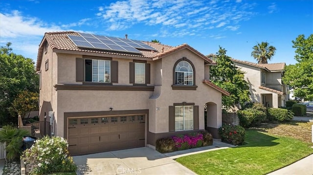 5794 Bay Hill Ln, Fontana, CA 92336 - view of front of house with a garage, stucco siding, roof mounted solar panels, and a tile roof