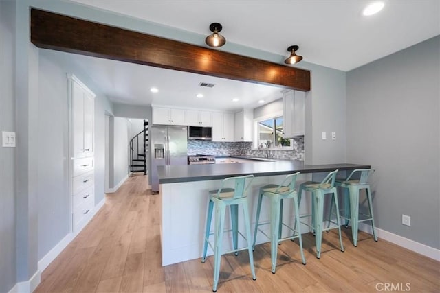280 Tally Ho Rd, Arroyo Grande, CA 93420 - kitchen featuring stainless steel appliances, a peninsula, baseboards, a sink, and white cabinets