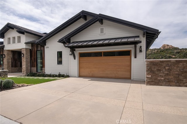 2775 Calbourne Ln, Westlake Village, CA 91361 - view of front of property featuring a standing seam roof, driveway, metal roof, and a garage