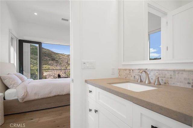 2775 Calbourne Ln, Westlake Village, CA 91361 - ensuite bathroom with vanity, tasteful backsplash, wood finished floors, and recessed lighting