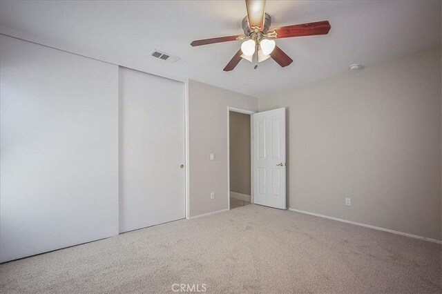 24347 Silver Bullet Way, Murrieta, CA 92562 - unfurnished bedroom featuring a closet, carpet, ceiling fan, and baseboards