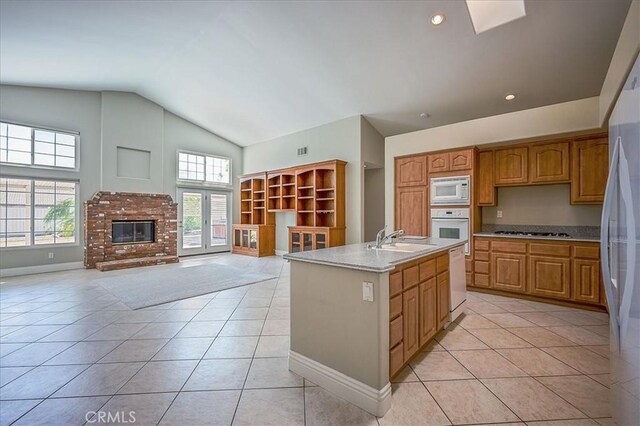 24347 Silver Bullet Way, Murrieta, CA 92562 - kitchen with white appliances, a sink, light tile patterned flooring, open floor plan, and vaulted ceiling