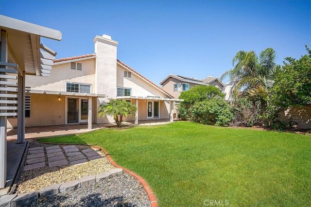 24347 Silver Bullet Way, Murrieta, CA 92562 - rear view of property with a chimney, stucco siding, and a patio area