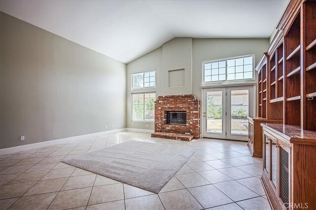 24347 Silver Bullet Way, Murrieta, CA 92562 - unfurnished living room featuring light tile patterned floors, high vaulted ceiling, a brick fireplace, and baseboards