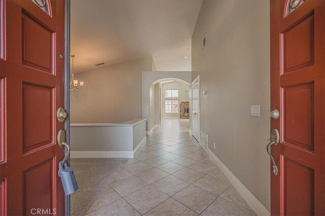 24347 Silver Bullet Way, Murrieta, CA 92562 - foyer with arched walkways, light tile patterned flooring, and baseboards