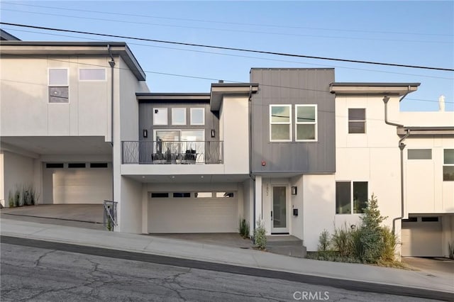 1802 Blossom Ln, Redondo Beach, CA 90278 - view of front of property with a balcony, an attached garage, stucco siding, and concrete driveway