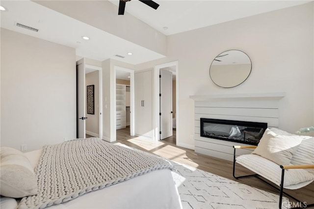 1802 Blossom Ln, Redondo Beach, CA 90278 - bedroom featuring wood finished floors, a glass covered fireplace, a ceiling fan, recessed lighting, and a spacious closet